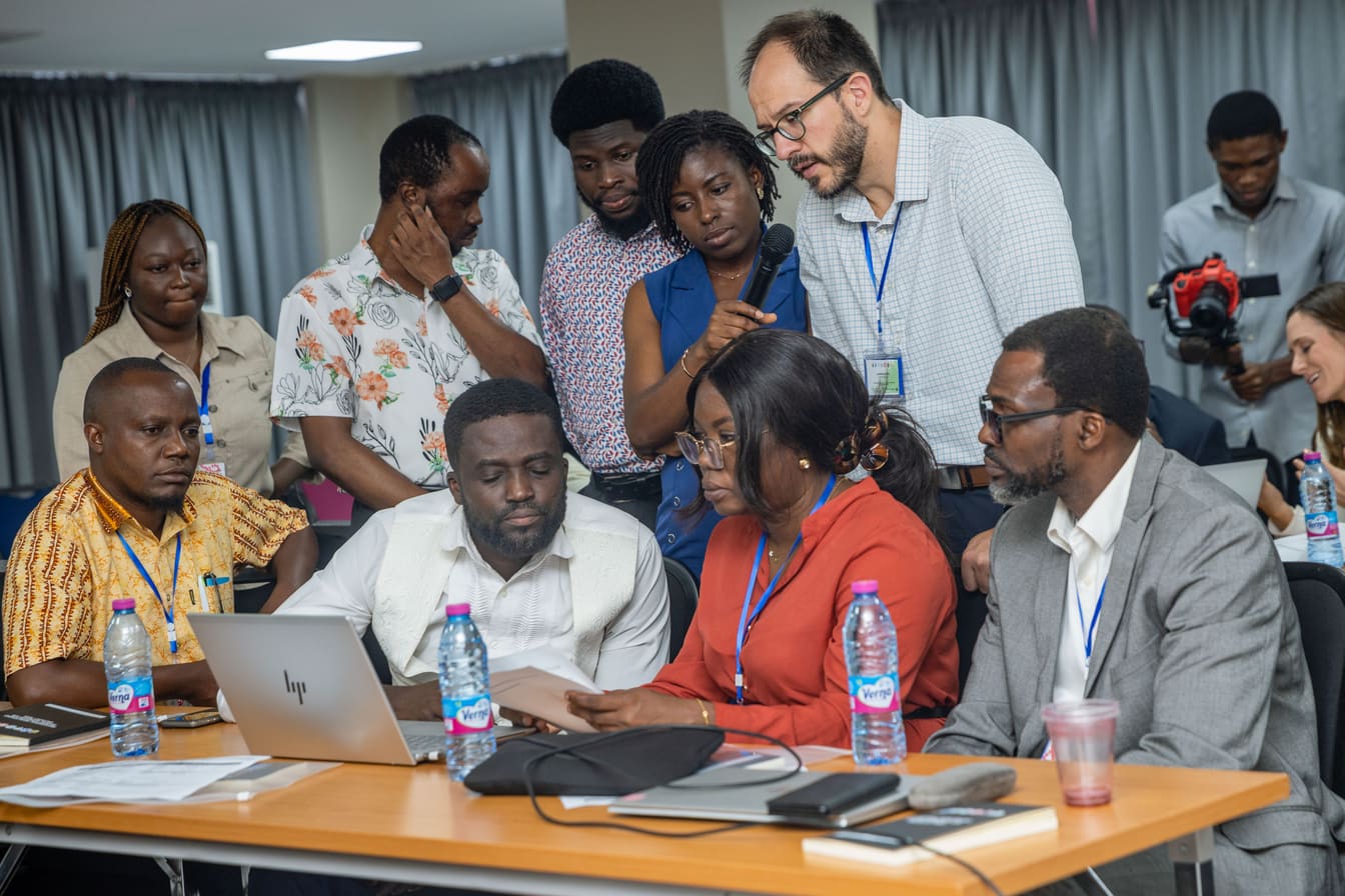 A participant asking a question during a discussion at the COTC Africa training workshop